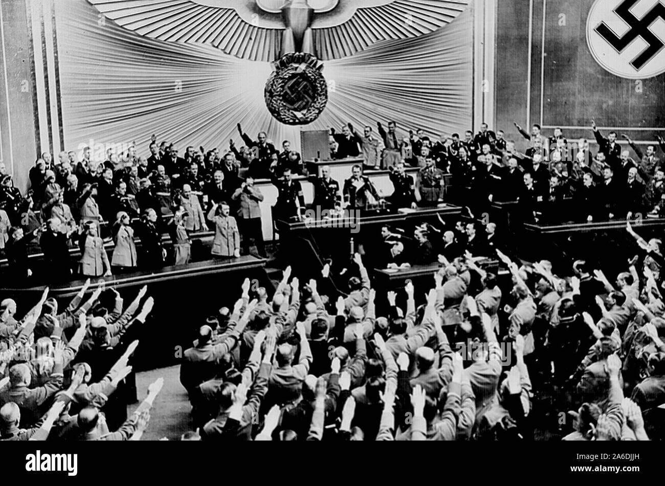 Hitler accepts the ovation of the Reichstag after announcing the `peaceful' acquisition of Austria. It set the stage to annex the Czechoslovakian Sudetenland, largely inhabited by a German- speaking population. Berlin, March 1938 Stock Photo